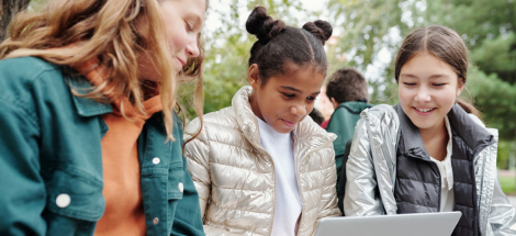 Middle school students doing homework together with a laptop