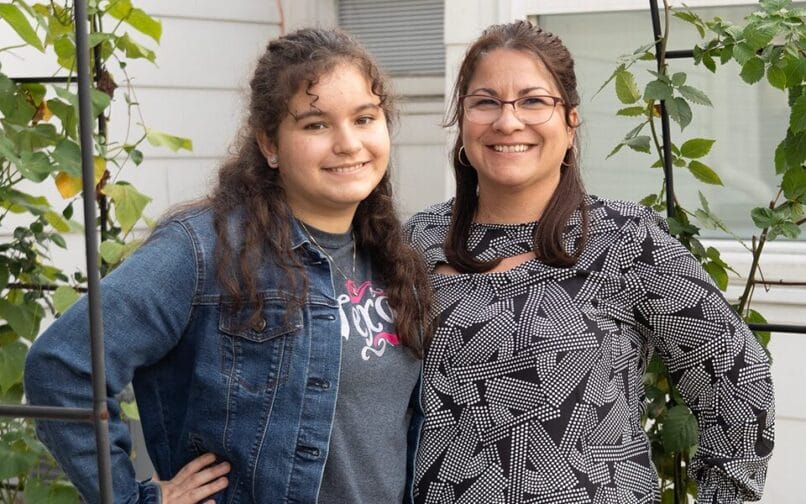 teacher and girl student smiling