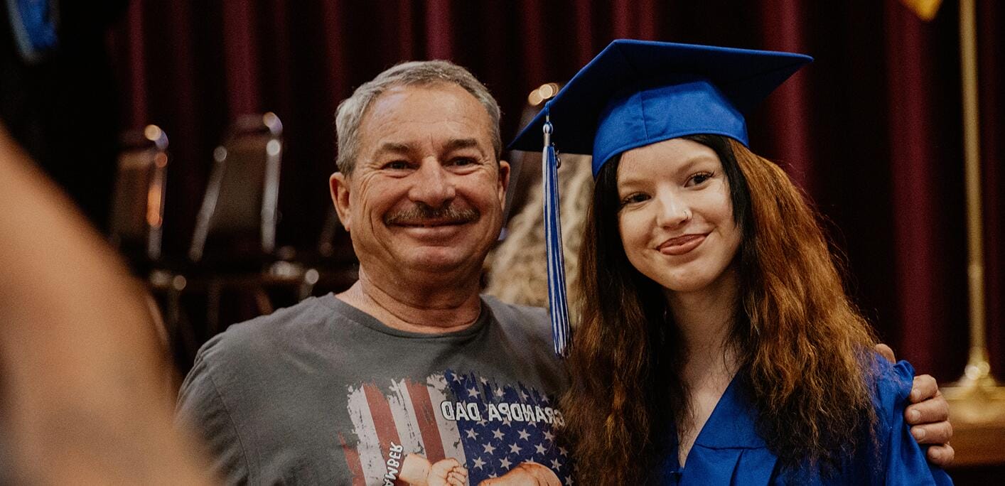 Father and her daughter at graduation ceremony