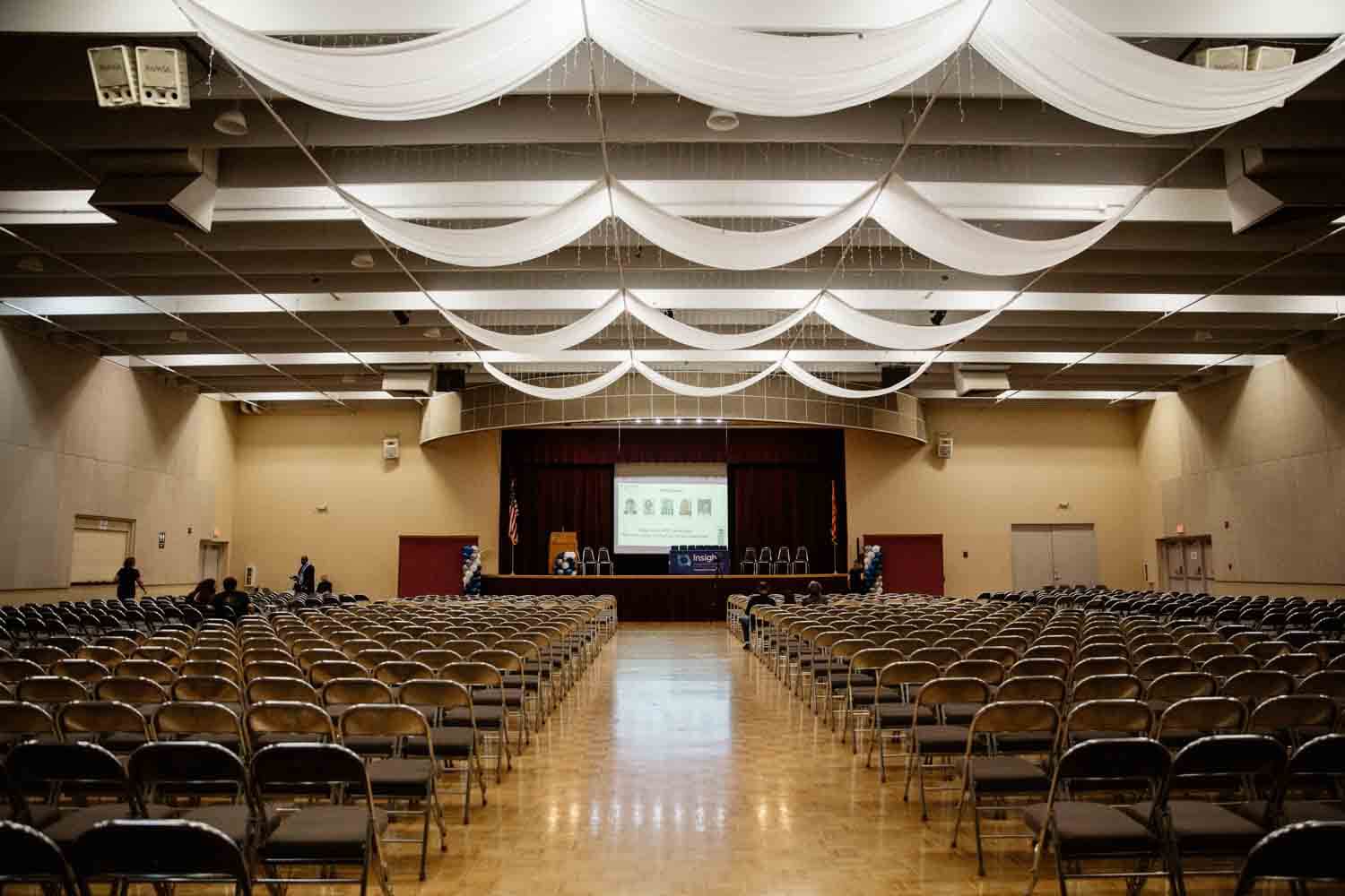 Spacious auditorium with rows of empty chairs