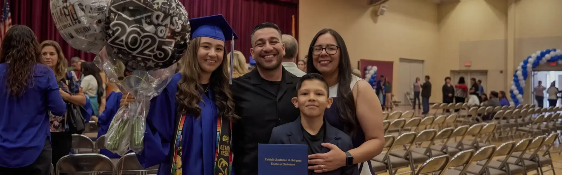 Graduated student and her familty at her graduation ceremony